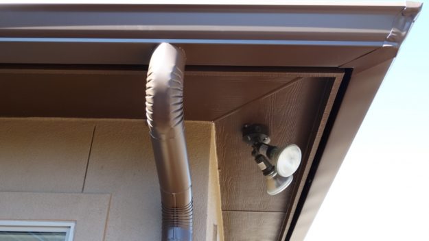 brown down spout next to floodlights