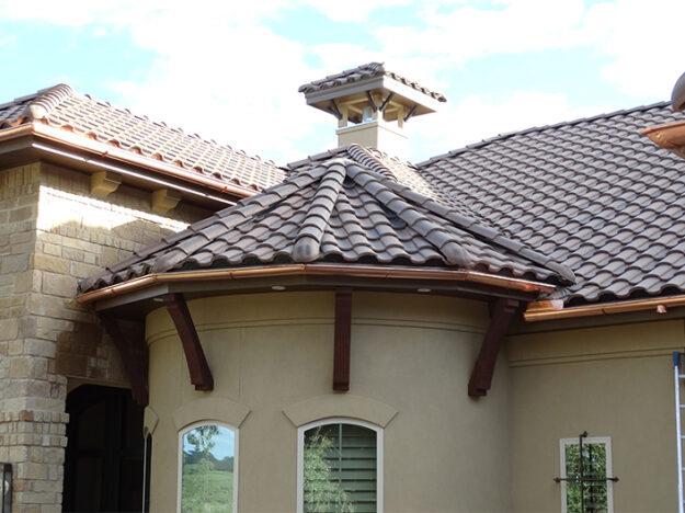 Copper gutter on cylindrical piece of a home