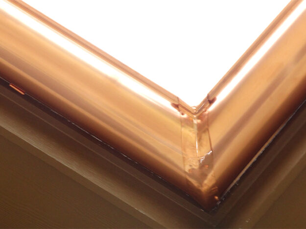 Angled corner piece of copper gutter