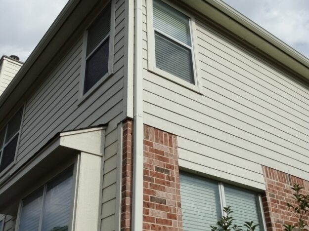 two story home with vinyl siding and downspout