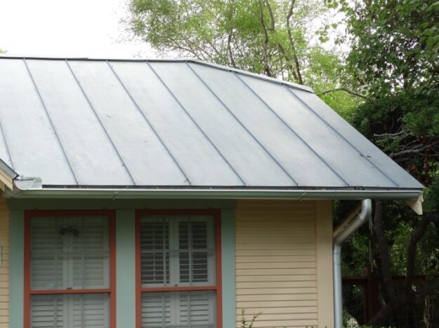 silver gutters with a side downspout