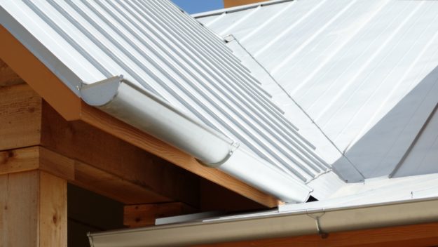 Metal gutters mounted to wood