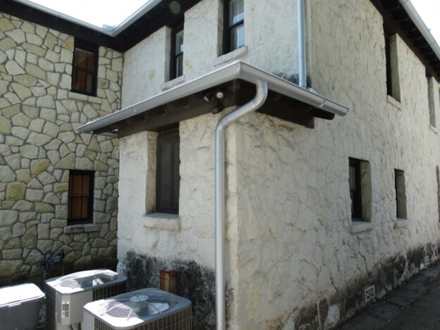 multi-level gutter system on a stone house
