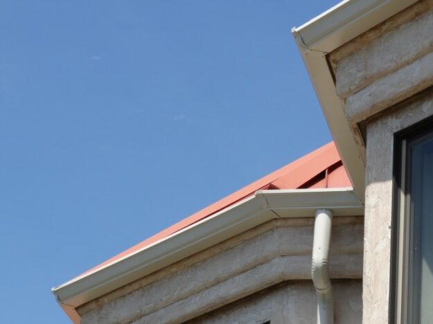 white gutters on the edge of a red roof