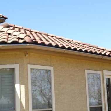 spanish tile roof and white gutters