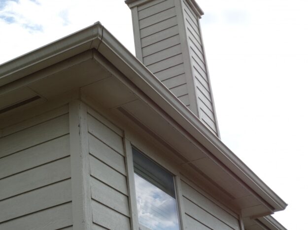 home with vinyl siding and white standard rain gutters