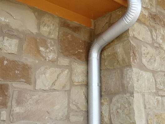 downspout-on-stone-house-orange