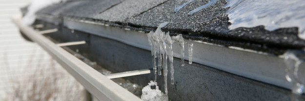 Ice on roof and gutters rooftop and gutters with ice and snow