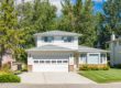 two story white home with white gutters and a gray roof